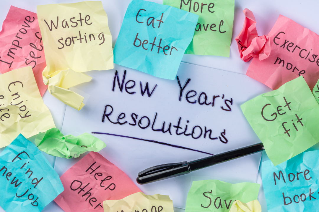 Colorful sticky notes with handwritten New Year's resolutions, such as 'Exercise more,' 'Save money,' and 'Eat healthier,' arranged in a circle on a white background.