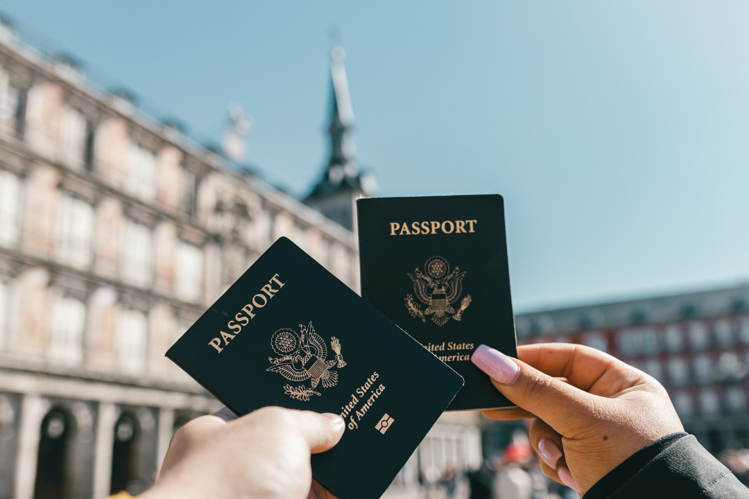 Close-up of multiple passports stacked together, symbolizing international travel and expat life.